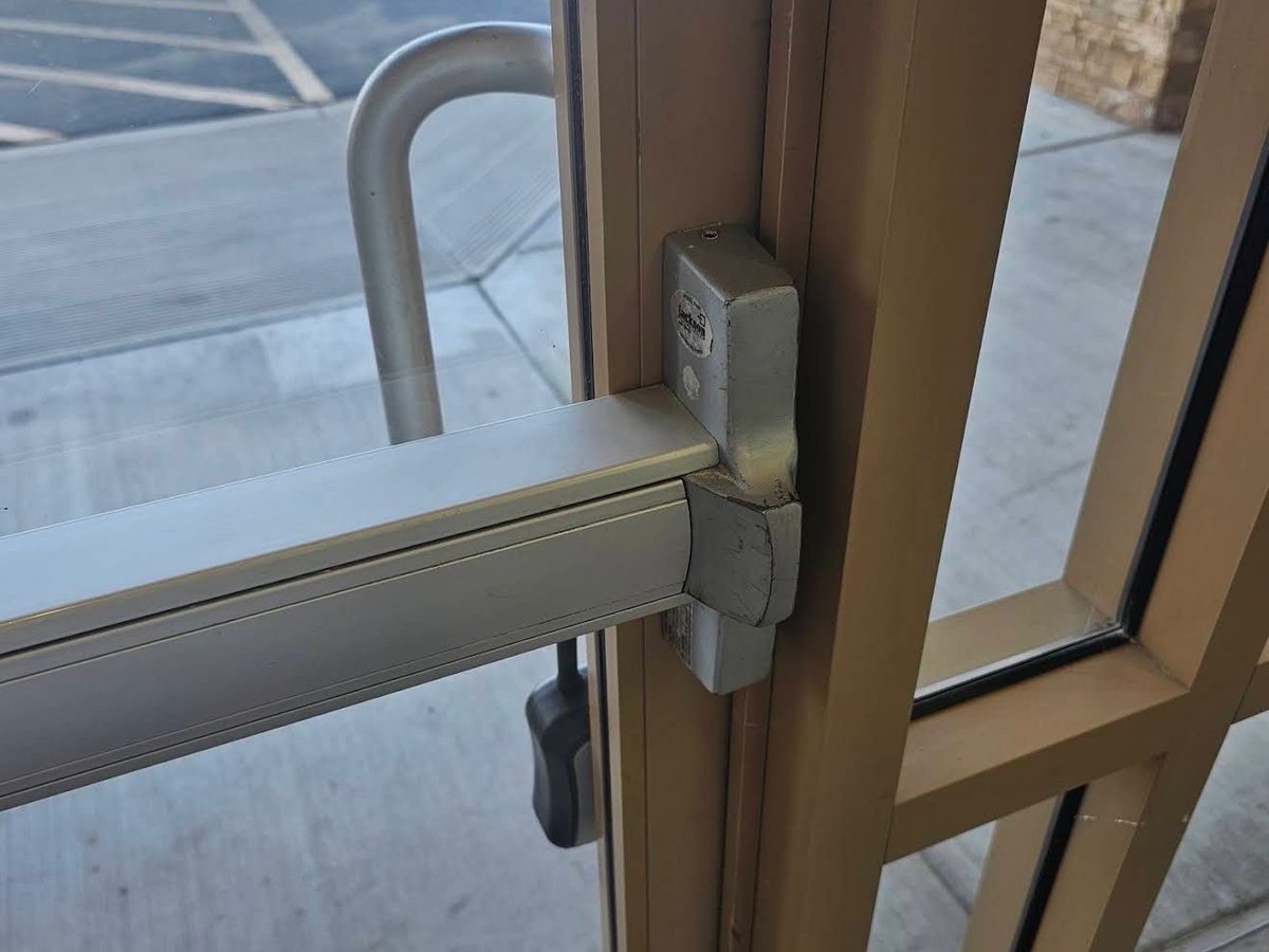 Panic bar exit device on the inside of a commercial door
