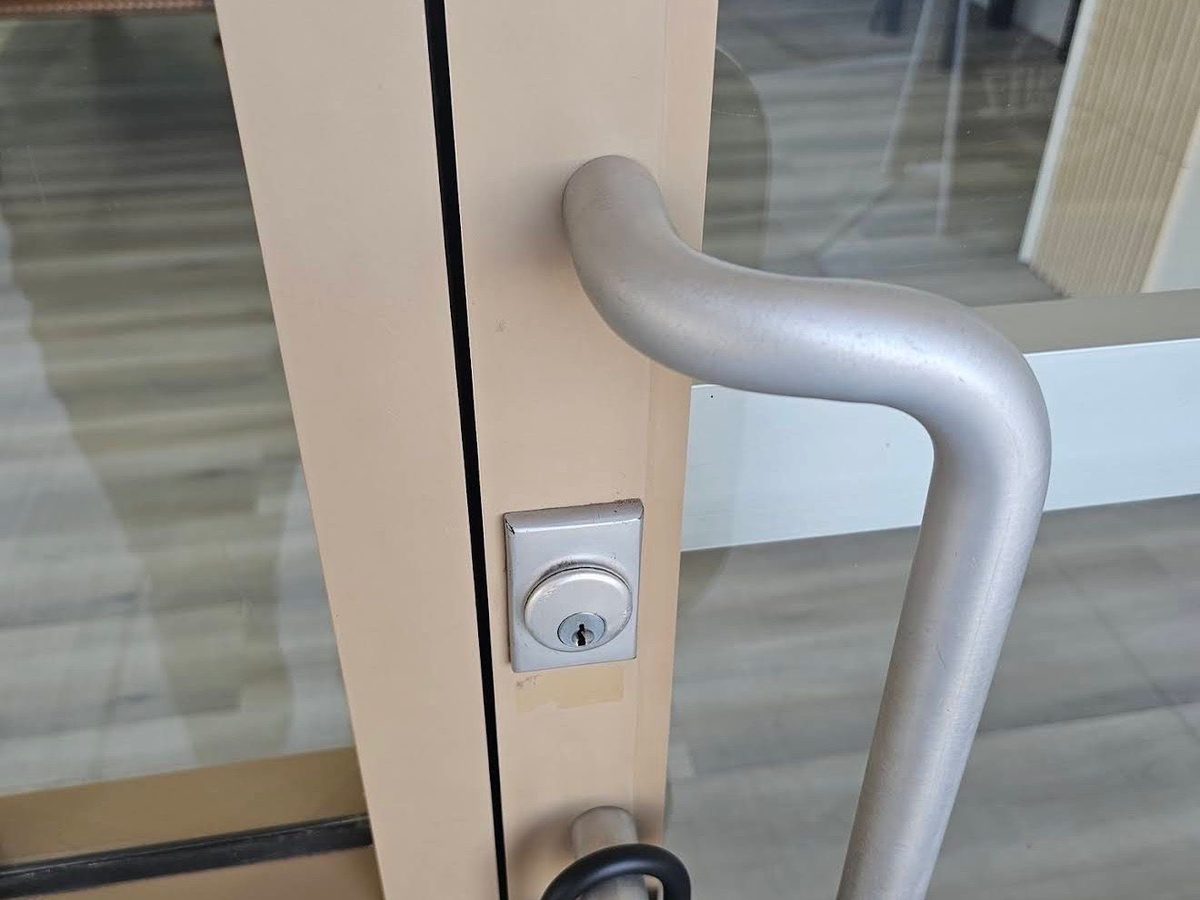 Commercial door handle with cylinder lock and padlock