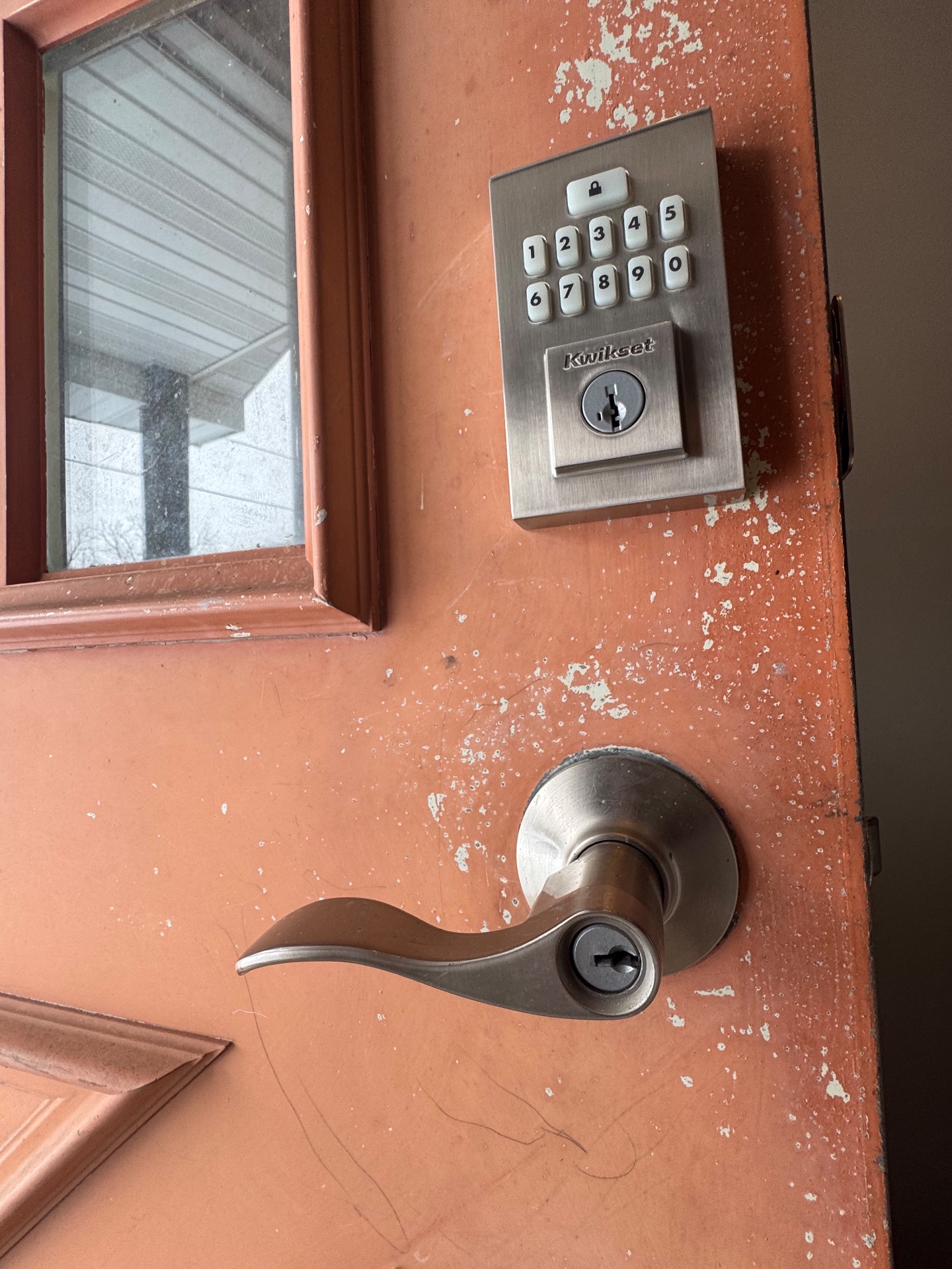 Damaged entry door being repaired and secured after a break-in
