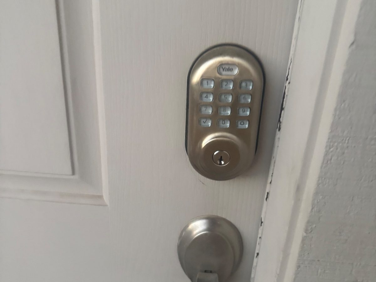 Yale keypad deadbolt and lever handle installed on a white door