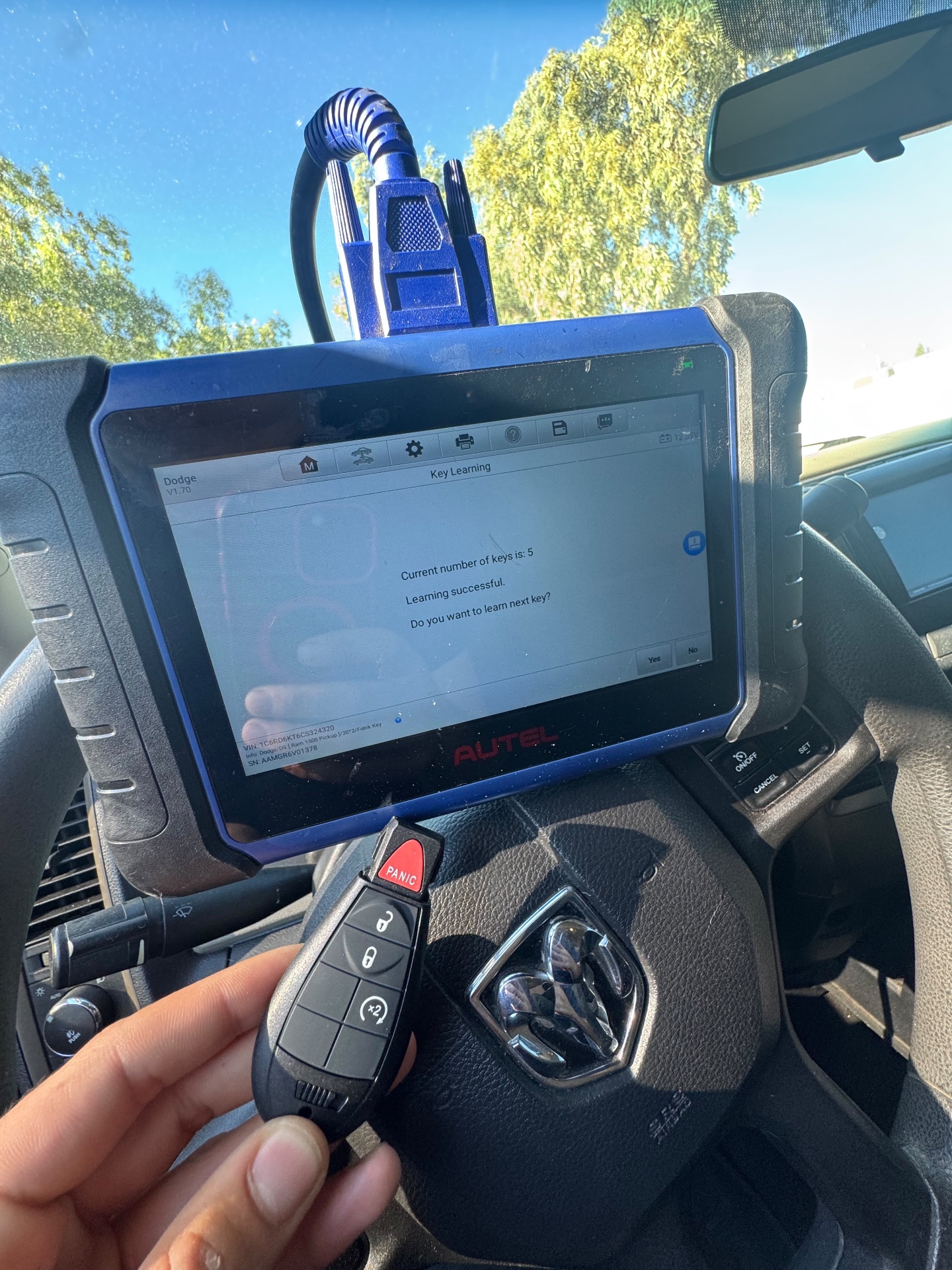 Key fob being programmed to a vehicle with a diagnostic tool
