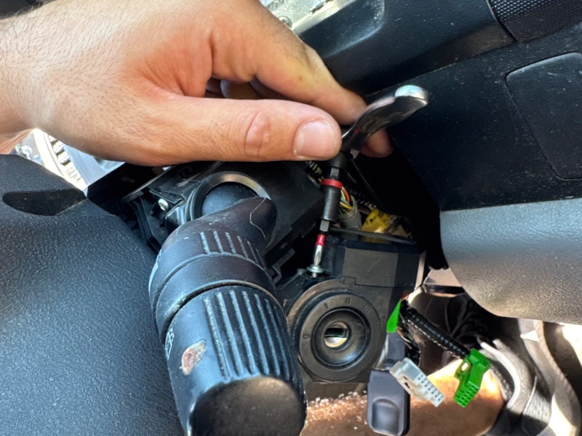 Technician working on a vehicle ignition cylinder